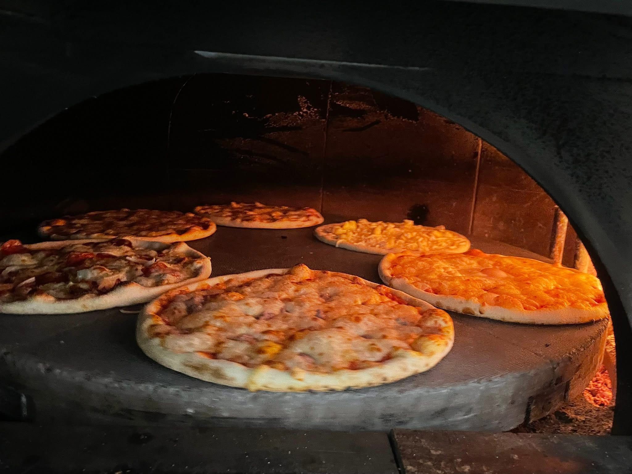 Pizze nel forno a legna